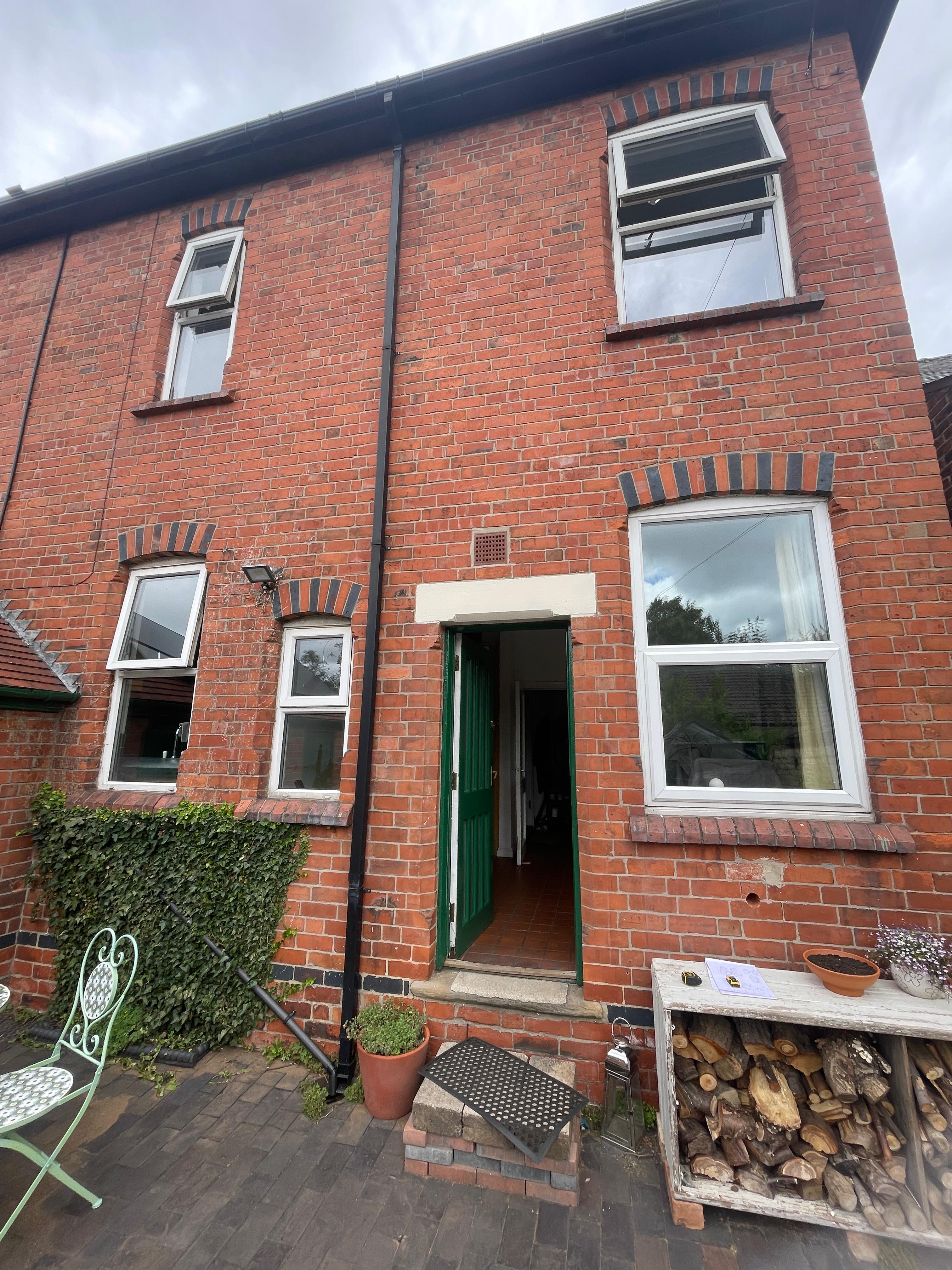 Old windows photographed for a free replacement window estimate in Nottingham